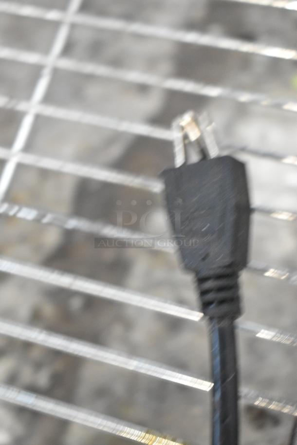Power cord of Avantco 193CAC48B commercial refrigerated merchandiser, showing a three-prong plug.