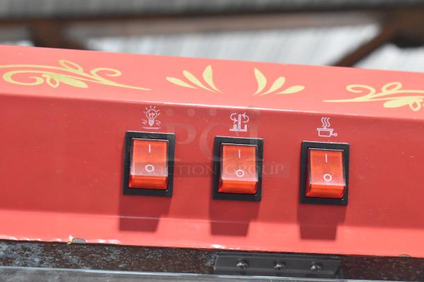 Great Northern 6128 popcorn machine controls; red panel with three labeled switches for light, heating, and motor functions.