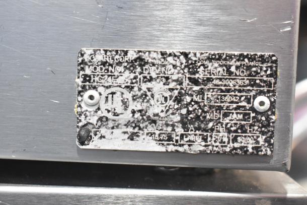 Hobart HC24EA3 steam cabinet metal tag showing model, serial number, and electrical specifications on worn surface.