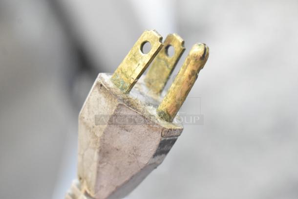 Close-up of a power plug with visible corrosion on the prongs, part of the Bizerba A330 meat slicer.