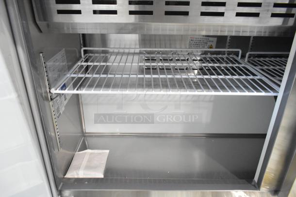 2024 Avantco 178APT60MHC stainless steel prep table interior with wire shelf and visible labeling. Commercial casters, 115V.