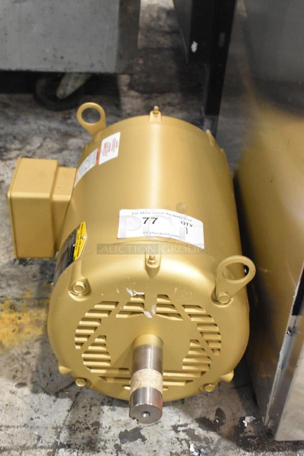 Baldor SuperE motor, like new, 230/460 volts, 3 phase. Gold casing with labels, model information, and auction tag visible.