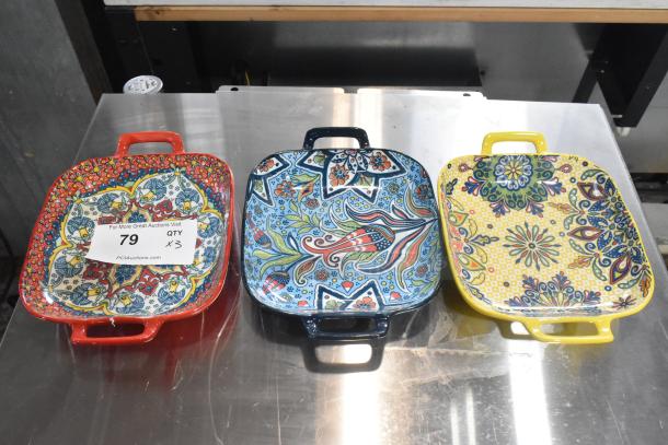 Three colorful ceramic dishes with handles, each with intricate patterns in red, blue, and yellow. Quantity tag reads “79, QTY x3.”