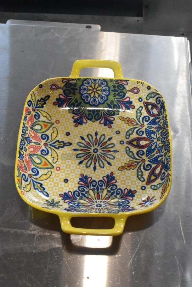 Colorful square dish with intricate floral patterns, yellow handles, and vibrant designs. Excellent condition.