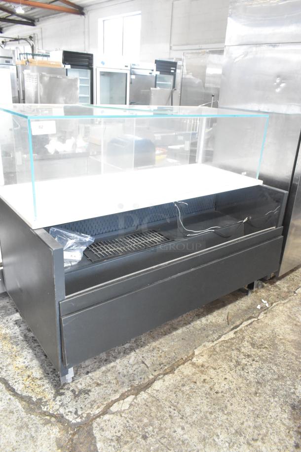 Metal commercial horizontal open merchandiser with top display case, black finish, minor wear, label number 82.