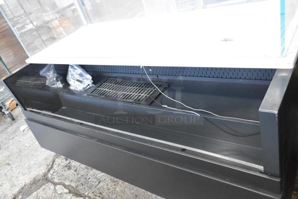 Metal commercial grab-n-go merchandiser with top display case, black finish, open front, and visible cables, used condition.