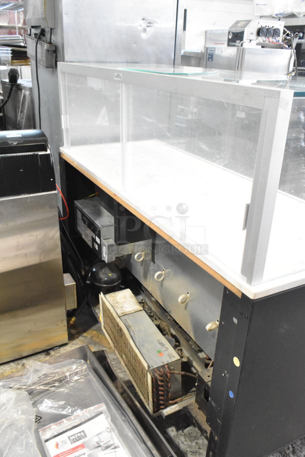 Metal commercial horizontal open grab-and-go merchandiser with top display case, in used condition, showcasing visible internal components.