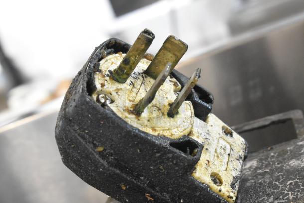 Close-up of a worn plug for an Alto Shaam CTP10-10E combi convection oven, showing corrosion and dirt buildup.