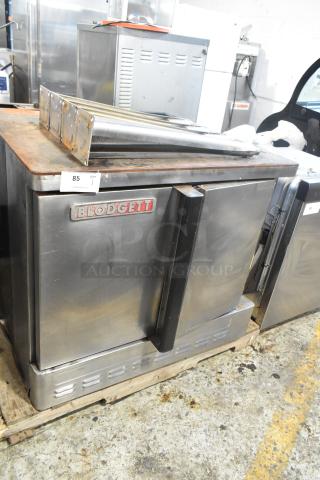 Blodgett stainless steel commercial convection oven with solid doors, metal racks, thermostatic controls, and metal legs.