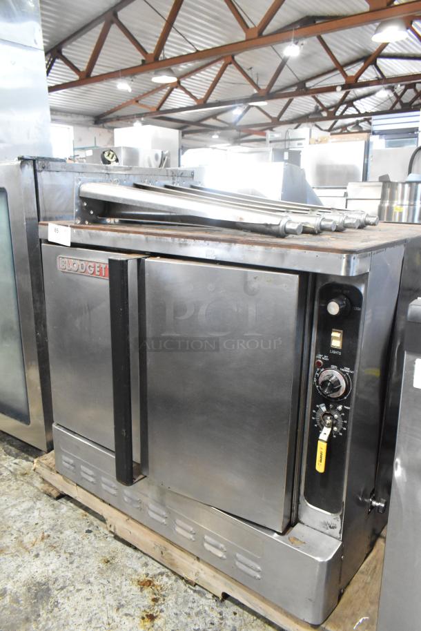 Blodgett stainless steel commercial convection oven with solid doors, metal racks, thermostatic controls, and metal legs.