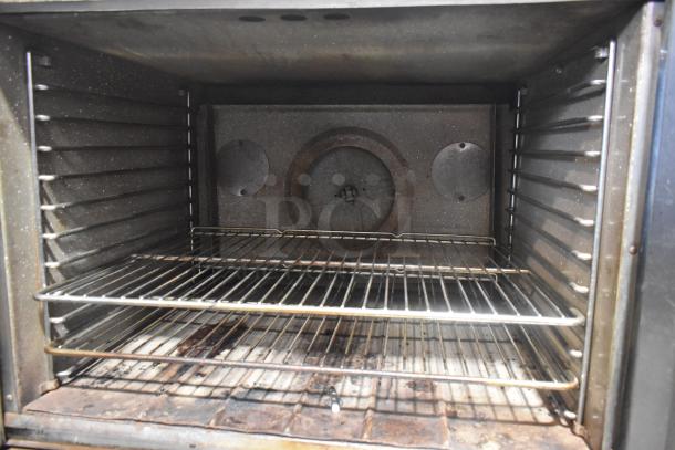 Blodgett stainless steel convection oven, full size, solid doors, metal racks, thermostatic controls, metal legs, used.
