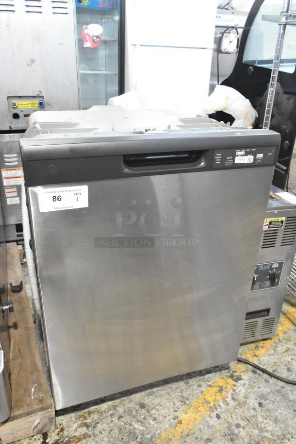 Stainless steel undercounter dishwasher in good condition with front control panel, visible labels on door indicating auction details.