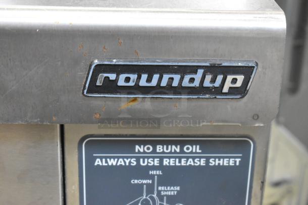 Roundup VCT-2000CS stainless steel commercial toaster, 208V, with visible round logo and release instructions.