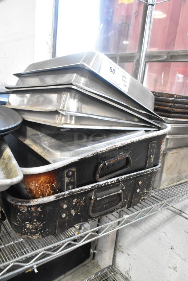 Metal baking pans, stainless steel drop-in bins, and poly lids; clearly used, visible wear on some items, auction lot number 88 tag.