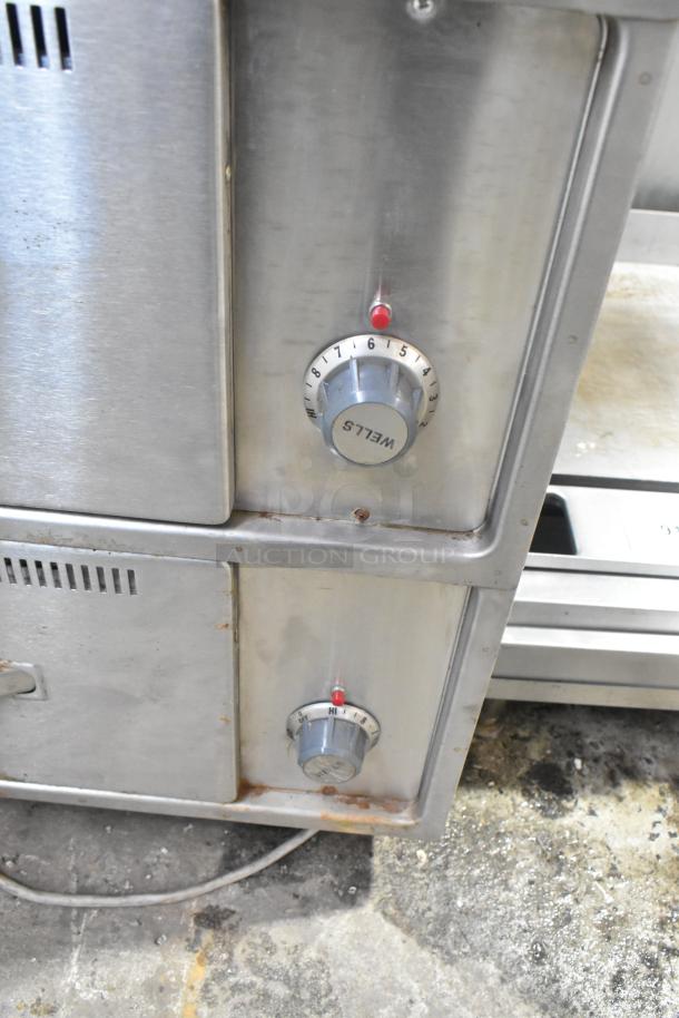 Wells RW-3 stainless steel warming drawer on casters, 3 drawers, 120V, showing control dials and minor wear.