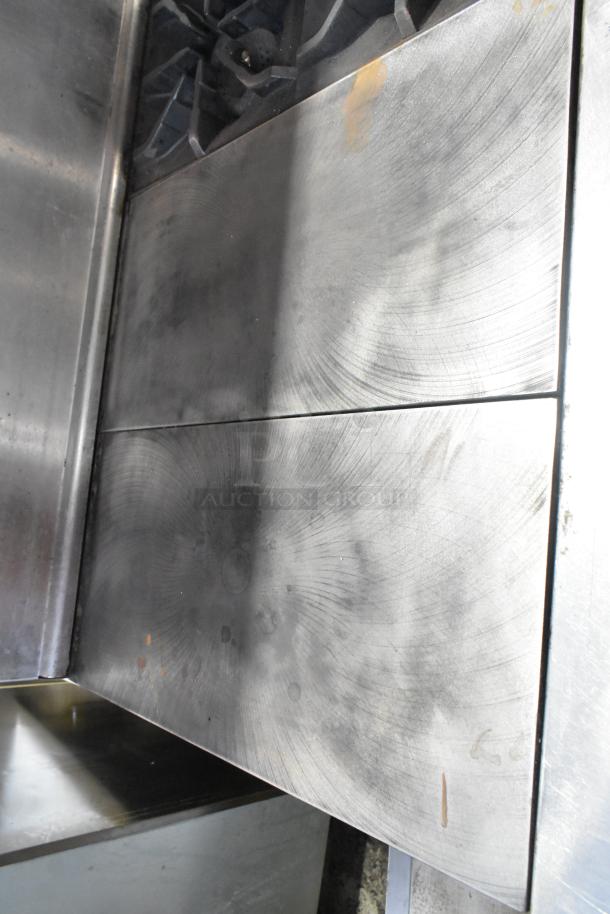 Imperial stainless steel commercial gas range with 6 burners, flat top griddle, convection oven, standard oven, shelf, and backsplash.