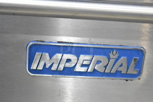 Imperial stainless steel commercial range with 6 burners, flat top griddle, convection and standard ovens, over shelf, and backsplash.
