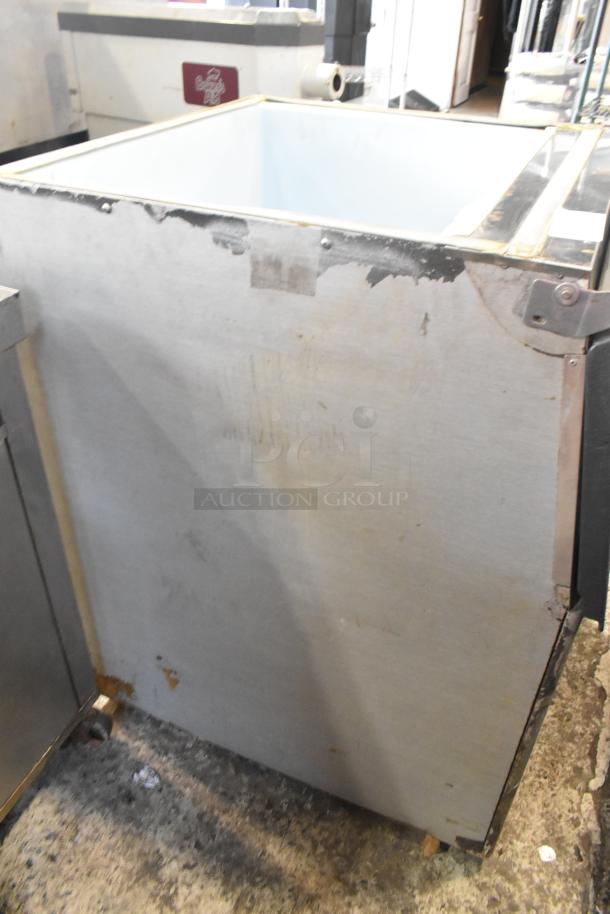 Stainless Steel Commercial Ice Bin, visible wear, sturdy design, suitable for restaurant use, exterior scuffs, no visible branding.