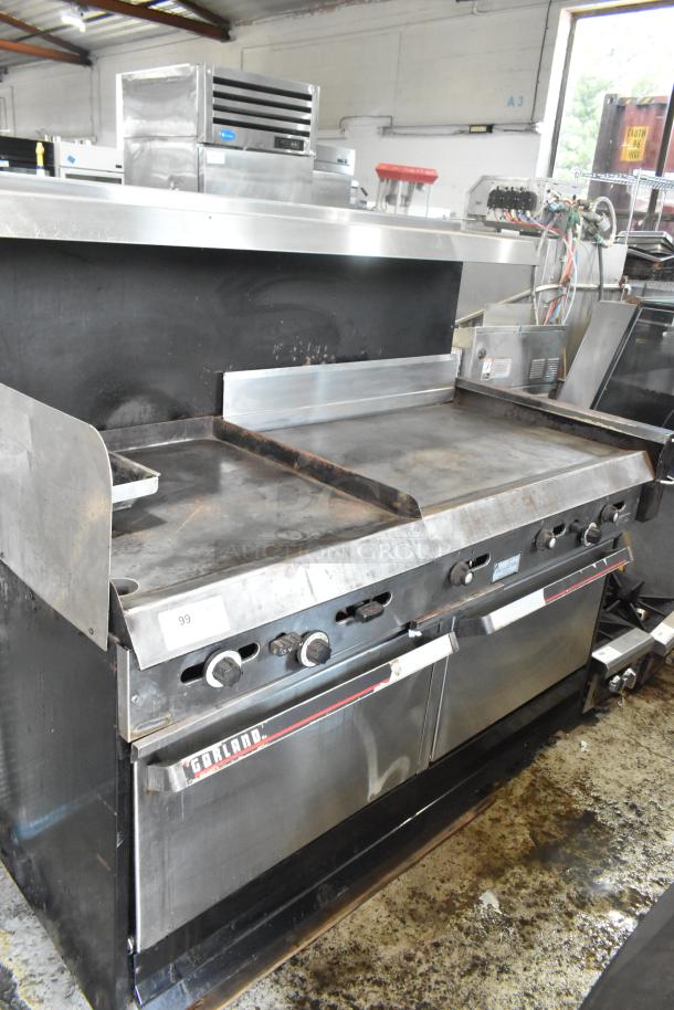 Garland stainless steel commercial gas griddle with two sections, featuring two ovens, overshelf, and backsplash. Appears used.