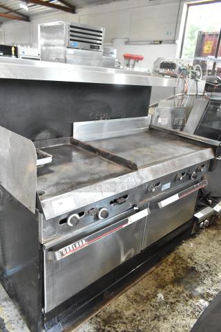 Garland stainless steel commercial gas griddle with two sections, featuring two ovens, overshelf, and backsplash. Appears used.