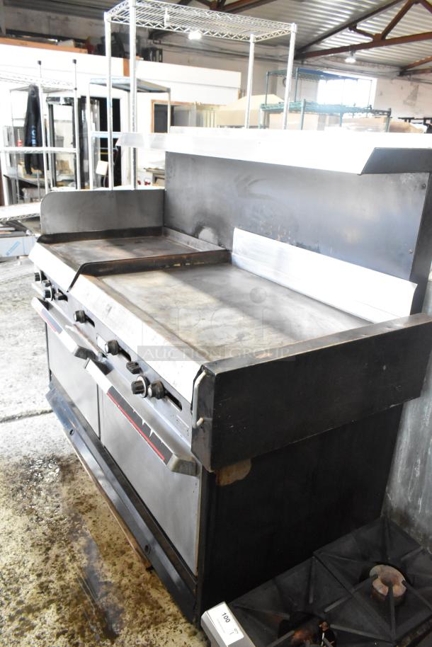 Garland stainless steel commercial gas griddle with two ovens, flat top, overshelf, and backsplash. Used condition.