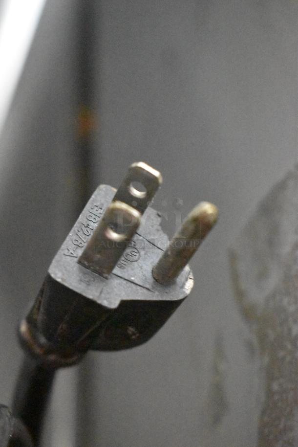 Power plug of Rational SelfCooking Center Combi Convection Oven; visible prongs and surface markings, indicating electrical specifications.