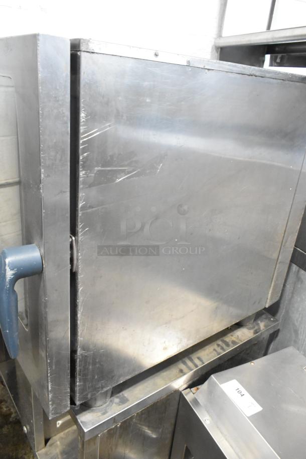 Rational SelfCooking Center stainless steel combi convection oven on double pan rack stand with commercial casters, visible wear.