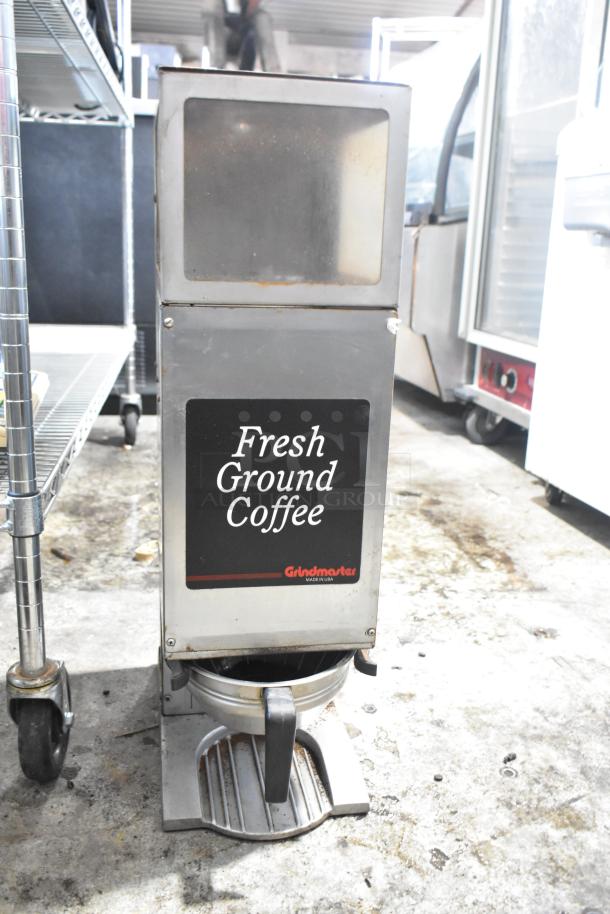 Grindmaster 115 stainless steel commercial coffee bean grinder, 115 volts, features "Fresh Ground Coffee" label, used condition.