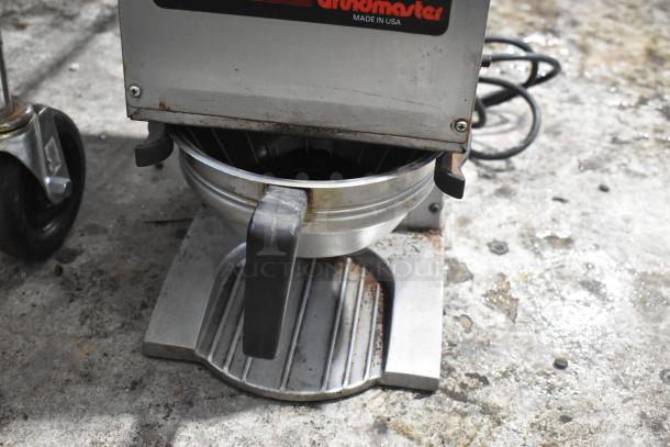 Grindmaster 115 stainless steel coffee grinder, commercial countertop model, visible wear, 115V, 1 phase, USA made label.