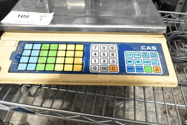 CAS AP-1 metal countertop food portioning scale with keypad, 120 volts, 1 phase. Shows signs of wear, auction tag attached.