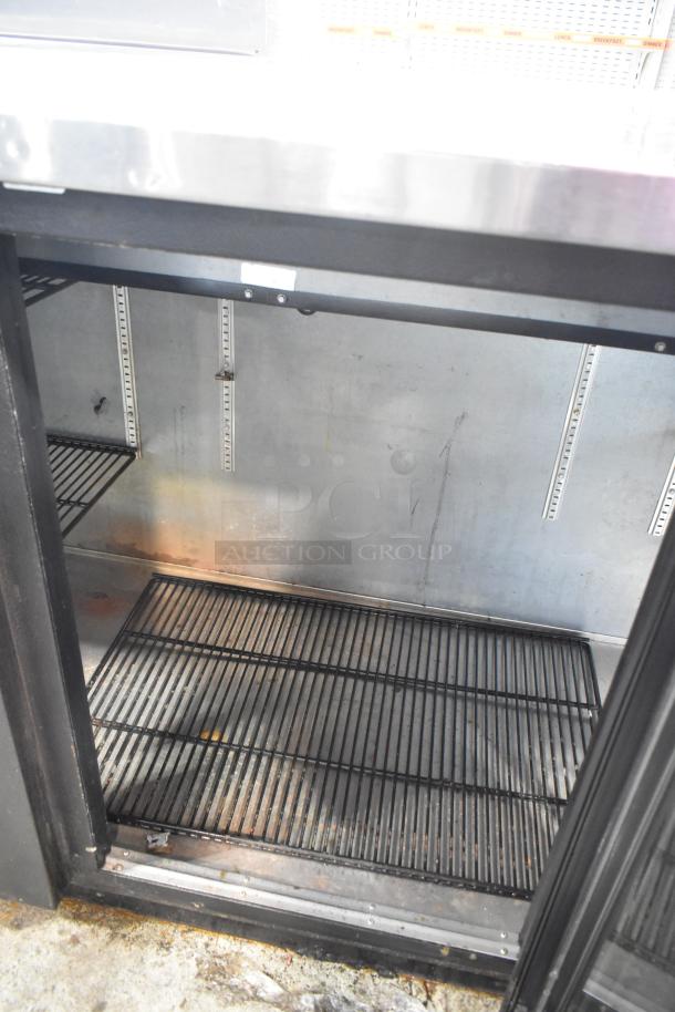 2017 True TBB-4G-LD 3-door metal commercial cooler, 115V, 1-phase, empty interior with wire shelving, good condition.