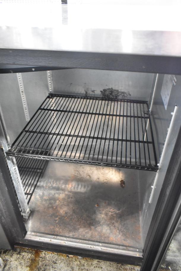 2017 True TBB-4G-LD metal commercial 3-door back bar cooler, 115 volts, 1 phase, interior shelves, visible wear.