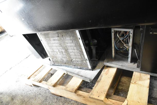 Master-Bilt metal commercial open merchandiser, missing one side panel, displayed on a wooden pallet.