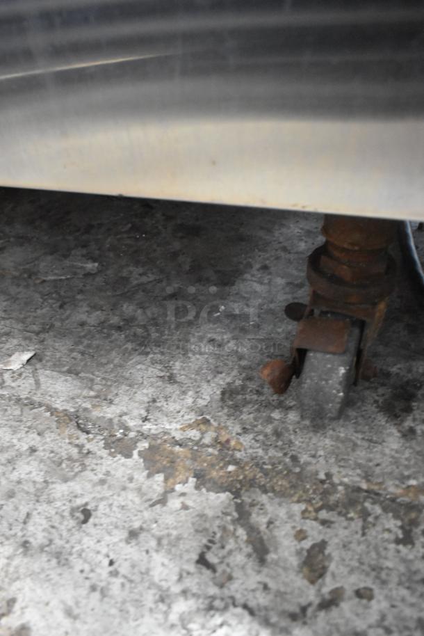 Electro Freeze 88T-CMT-113 ice cream machine caster on concrete floor; shows rust and wear.
