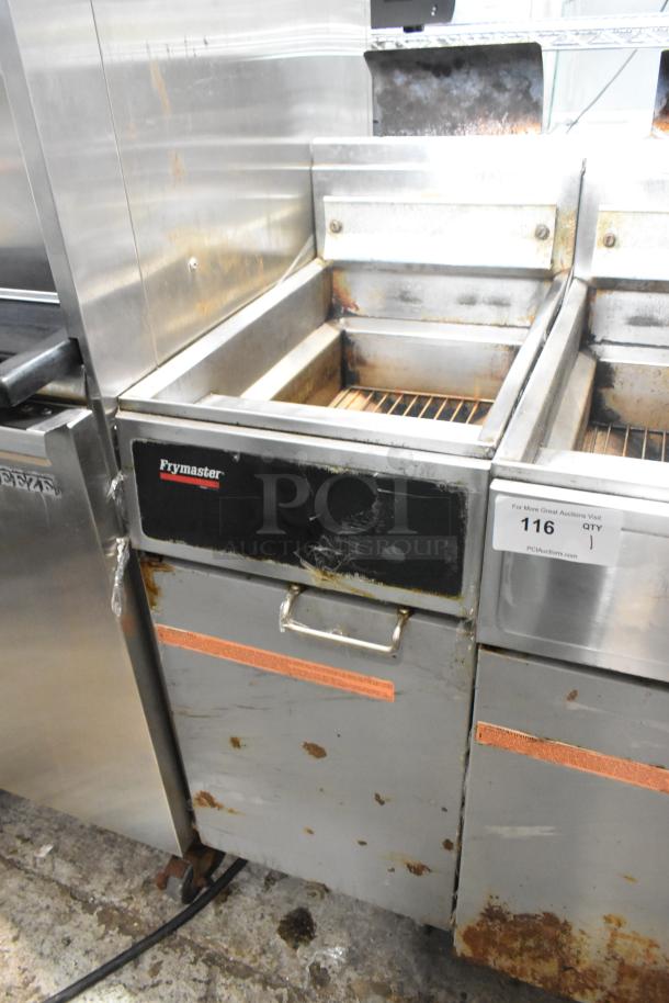 Frymaster GF14SP propane gas fryer. 100,000 BTU. Metal construction. Signs of wear and rust. Auction tag visible.