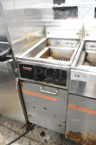 Frymaster GF14SP propane gas fryer. 100,000 BTU. Metal construction. Signs of wear and rust. Auction tag visible.