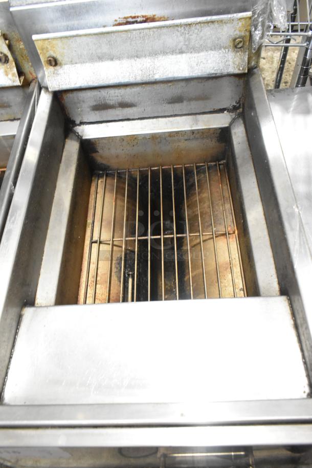 Frymaster GF14SP propane deep fryer, 100,000 BTU, metal, commercial floor style, visible grill, signs of use.
