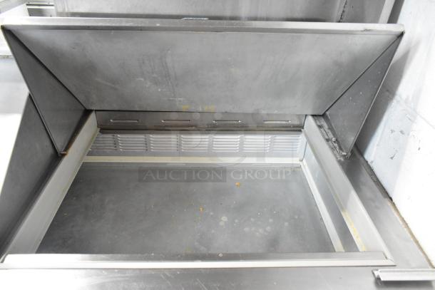 Beverage Air SP72-30M stainless steel sandwich prep table with open top view. Clean interior, commercial grade, on casters.