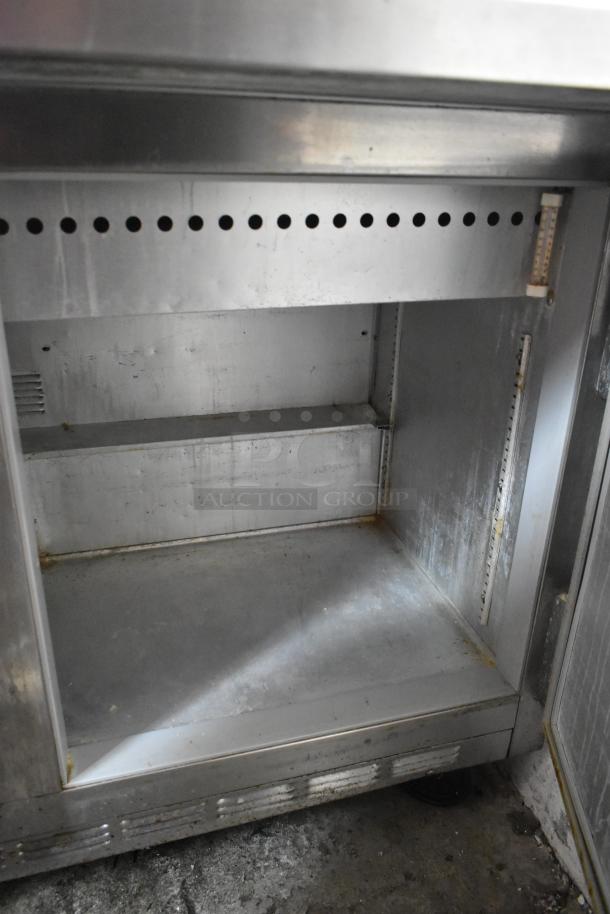 Beverage Air SP72-30M stainless steel commercial prep table interior, shows wear. Features bain marie mega top, 2-tier over shelf.