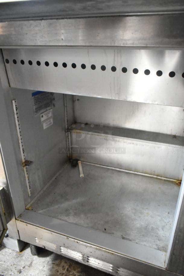 Beverage Air SP72-30M stainless steel sandwich prep table, worn condition, visible labels, commercial casters.