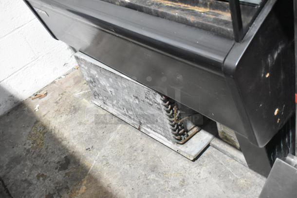 Master-Bilt metal commercial reach-in Grab N Go merchandiser, black finish, visible wear on the base, suitable for retail use.