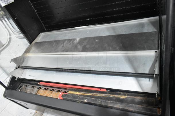 Master-Bilt metal commercial reach-in Grab N Go merchandiser. Features metal shelves, black and silver finish, and interior space. Suitable for retail use.