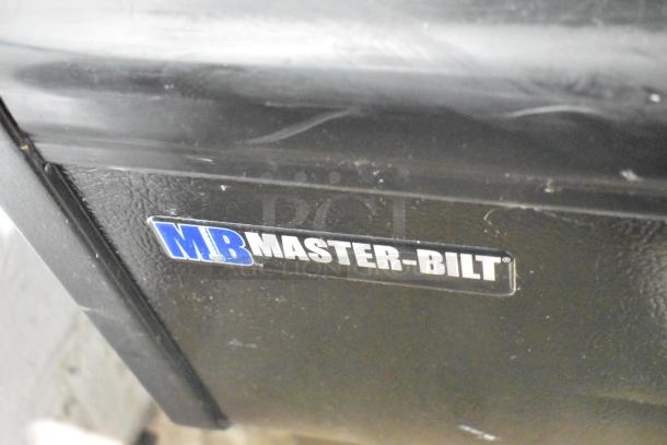 Master-Bilt metal commercial Grab N Go merchandiser with visible brand label. Slight wear on exterior surface.