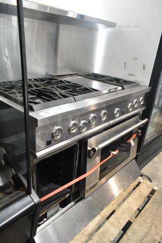 Jenn-Air stainless steel commercial 6 burner range with oven, over shelf, and backsplash in good condition, model visible.