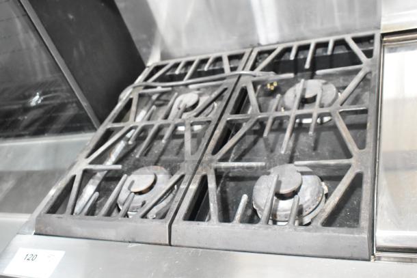 Jenn-Air stainless steel commercial 6 burner range with oven, over shelf, and backsplash in good condition. Item tag 120 visible.