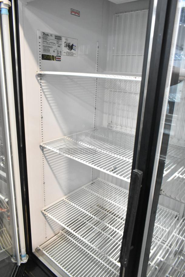 True GDM-49F commercial freezer with two doors, metal frame, and poly-coated racks, 115/208-230V, 1 phase.