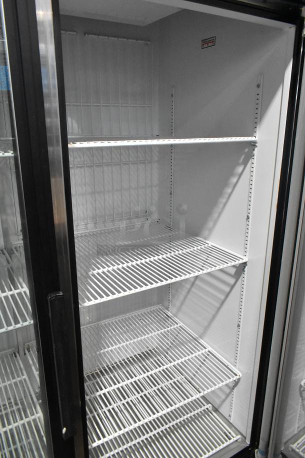 True GDM-49F commercial freezer, 2 glass doors, poly-coated racks, 115/208-230 volts, 1 phase, clean interior.