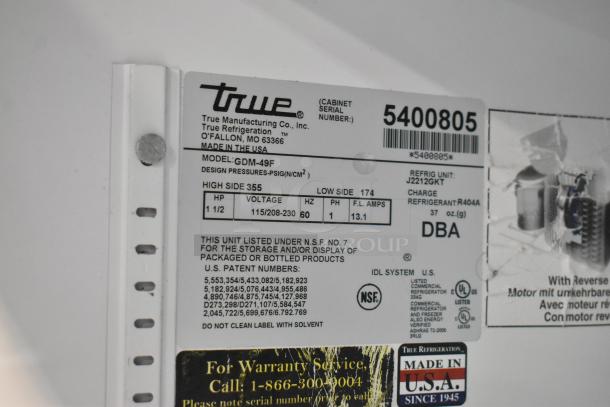 True GDM-49F commercial freezer label showing model details and power specs; 115/208-230V, 1 phase. Made in USA.