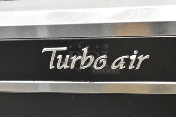Turbo Air TOM-72E merchandiser logo close-up, highlighting metal finish and brand marking on commercial appliance.