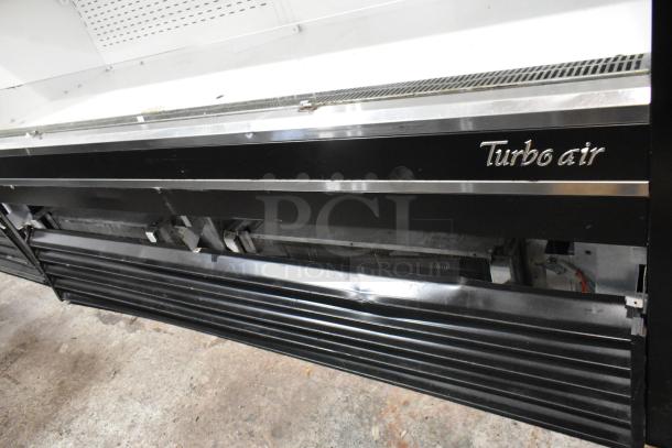 Turbo Air TOM-72E commercial open merchandiser with metal shelves, 220V, 1 phase; visible wear on exterior.